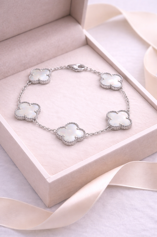 Silver bracelet with white stones in a pink jewelry box