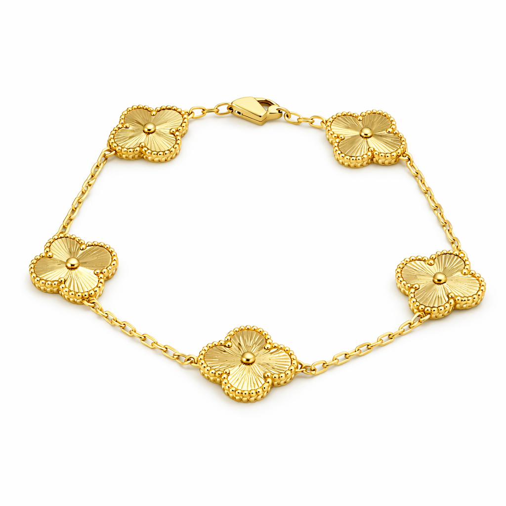Gold bracelet with floral designs on a white background