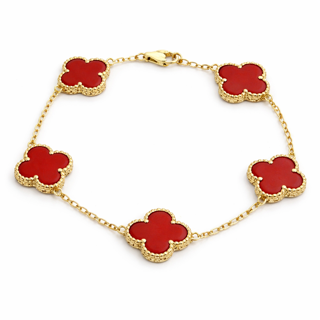 Gold bracelet with red clover-shaped charms on a white background