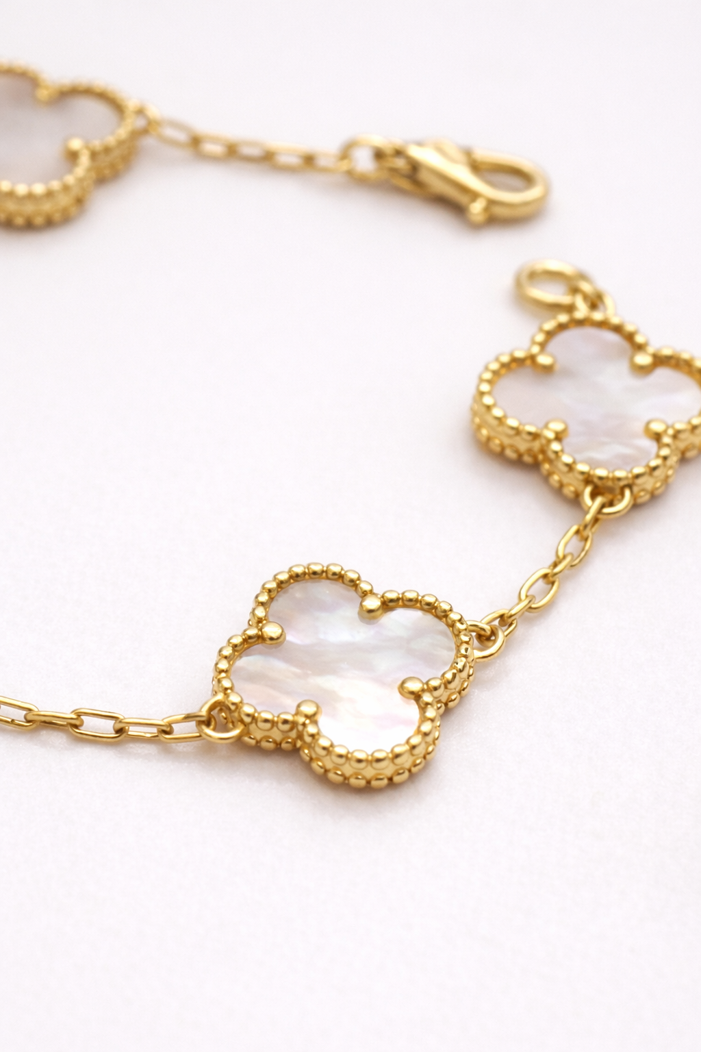 Mother of pearl clover charm in 925 sterling silver with 18K gold plated finish
